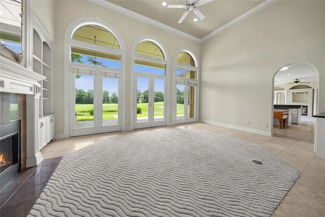 a view of an empty room with a fireplace and a window