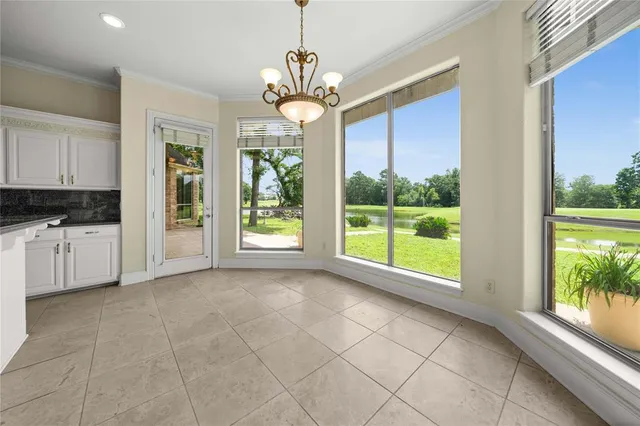 a view of a kitchen with furniture and a large window
