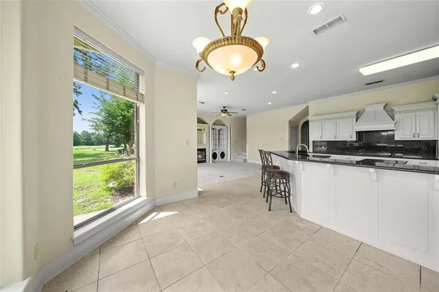 a large kitchen with stainless steel appliances granite countertop a stove and a refrigerator
