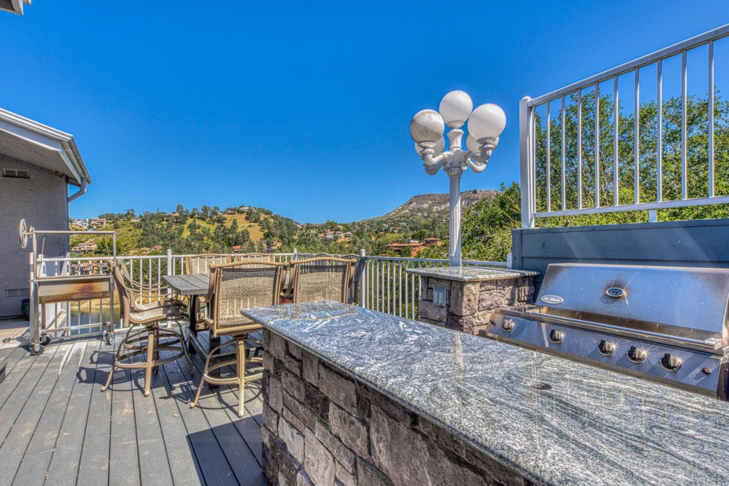 8213 Bass Point Road Bradley, CA 93426 - Photo 34 of 58 a view of a roof deck with table and chairs with wooden floor