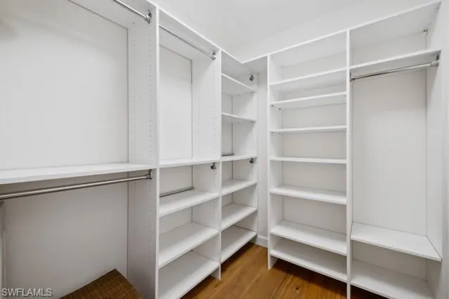a bathroom with a granite countertop sink a toilet a mirror and shower