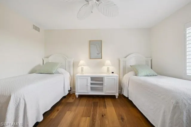 a view of a bedroom with furniture and wooden floor