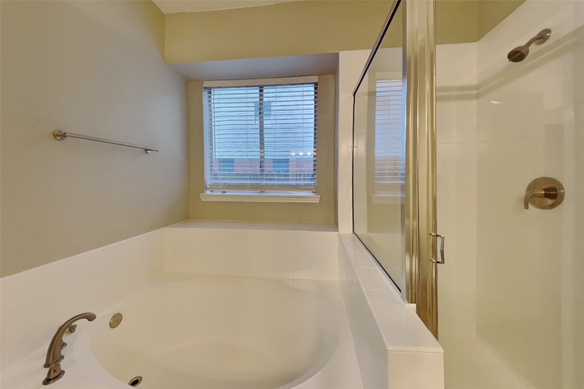 16411 Willingham Way Houston, TX 77095 - Photo 11 of 21 a bathroom with a bathtub and shower