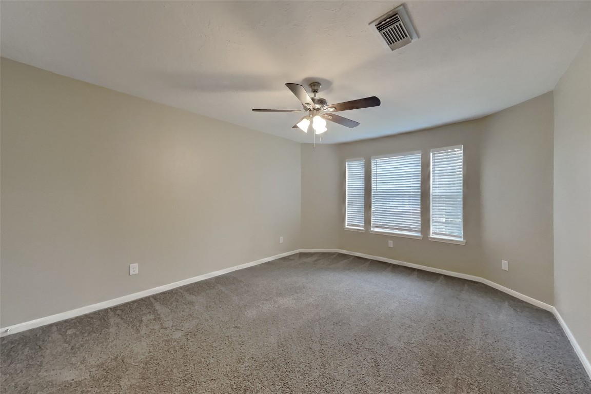 16411 Willingham Way Houston, TX 77095 - Photo 14 of 21 an empty room with windows and fan
