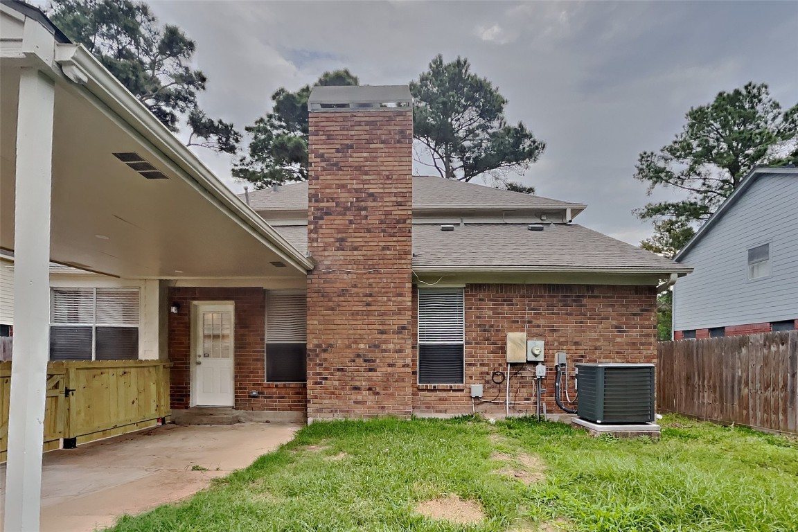 16411 Willingham Way Houston, TX 77095 - Photo 17 of 21 a view of a house with brick walls and a yard with a large tree