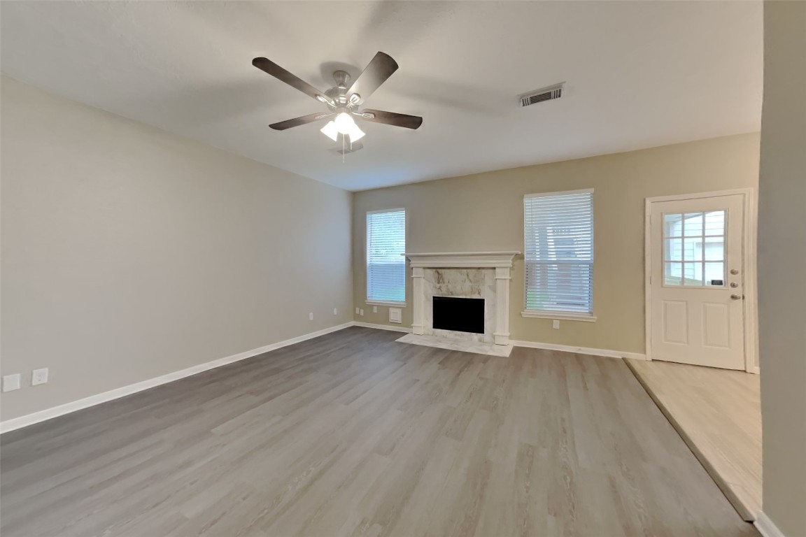 16411 Willingham Way Houston, TX 77095 - Photo 3 of 21 a view of empty room with wooden floor and fan