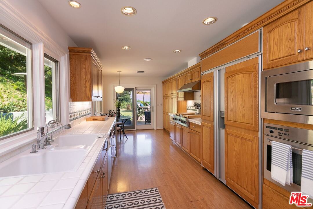 10935 Alta View Drive Studio City, CA 91604 - Photo 12 of 45 a kitchen with stainless steel appliances granite countertop a refrigerator and a sink