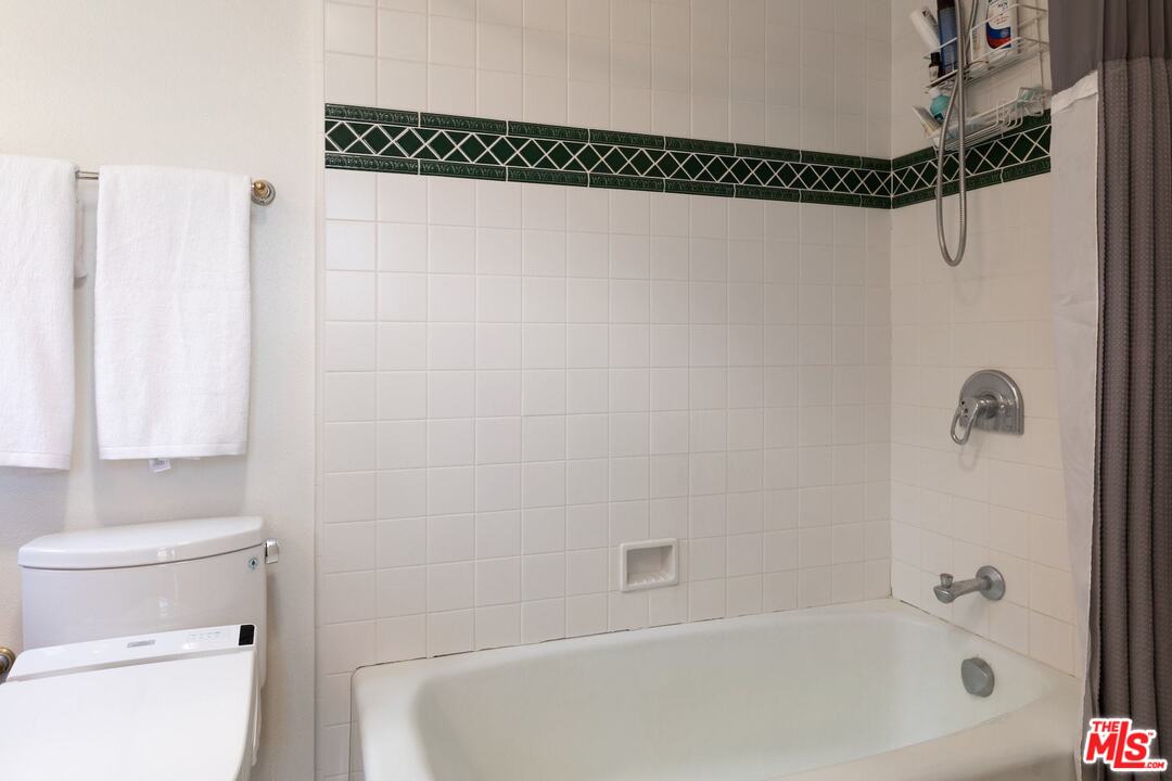 10935 Alta View Drive Studio City, CA 91604 - Photo 23 of 45 a bathroom with a shower a toilet and a window