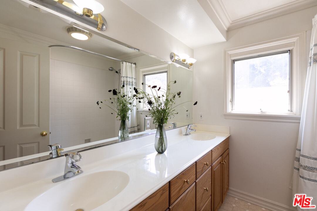 10935 Alta View Drive Studio City, CA 91604 - Photo 29 of 45 a bathroom with a sink and a mirror