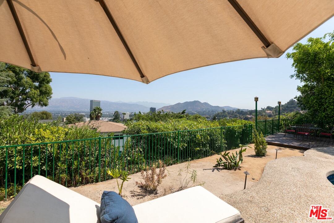 10935 Alta View Drive Studio City, CA 91604 - Photo 34 of 45 a view of a patio with a table and chairs under an umbrella