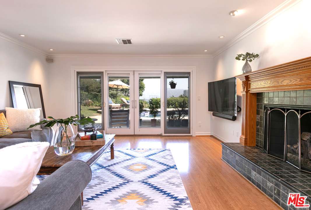 10935 Alta View Drive Studio City, CA 91604 - Photo 7 of 45 a living room with furniture large window and a fireplace