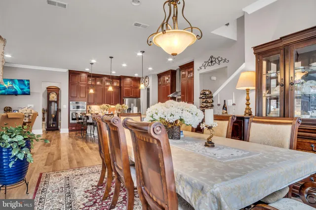 a view of a dining room with furniture wooden floor and chandelier