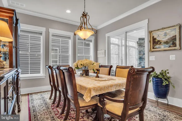 a living room with furniture a flat screen tv and a floor to ceiling window