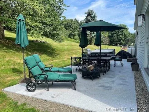 an outdoor space with furniture and garden