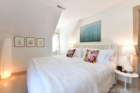 a bedroom with a bed and a night stand