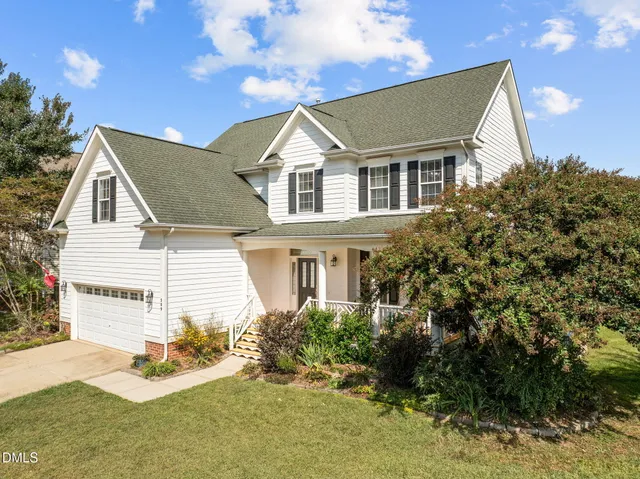 a view of house with yard and green space