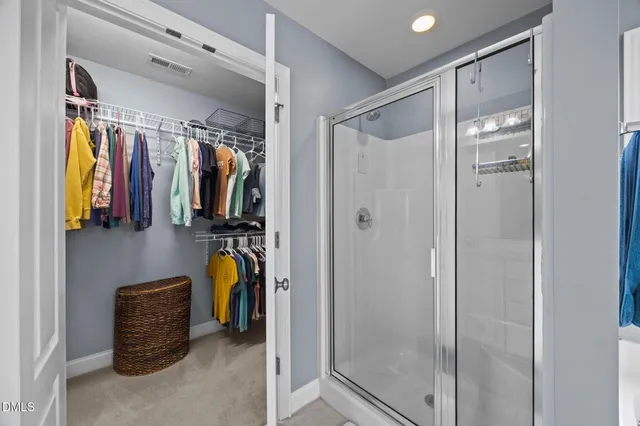 a bathroom with a glass shower door