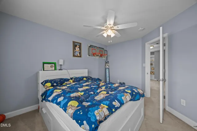 a spacious bedroom with a bed and a chandelier