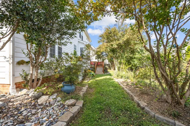 a view of a house with a yard and sitting area