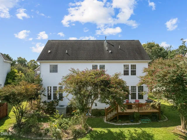 an aerial view of residential houses with outdoor space and parking