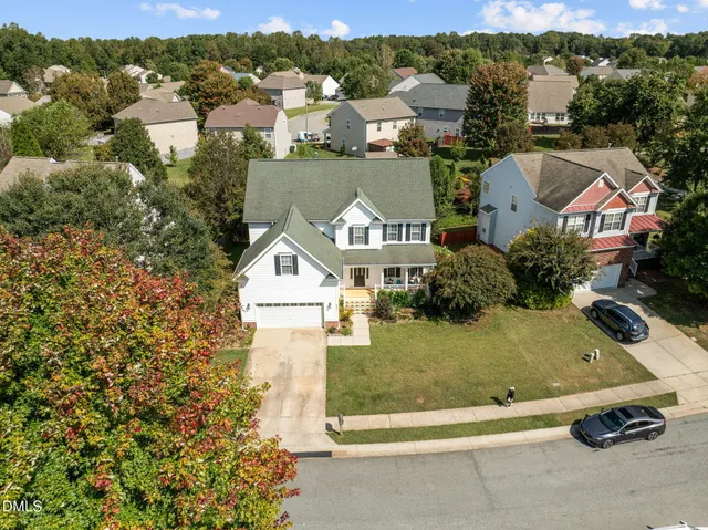 an aerial view of a house with outdoor space