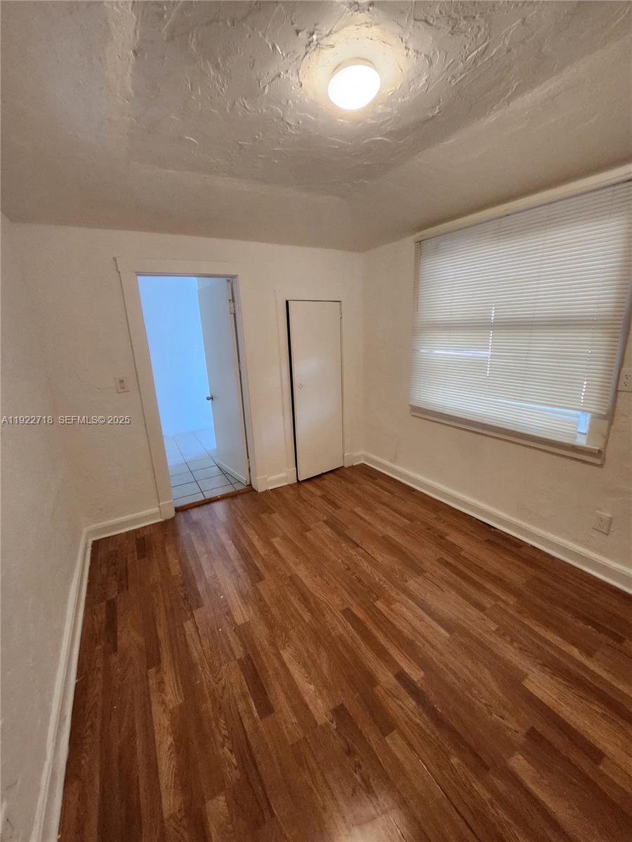 2129 Taylor Street Hollywood, FL 33020 - Photo 6 of 9 an empty room with wooden floor and windows