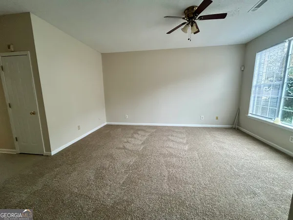 an empty room with windows and closet