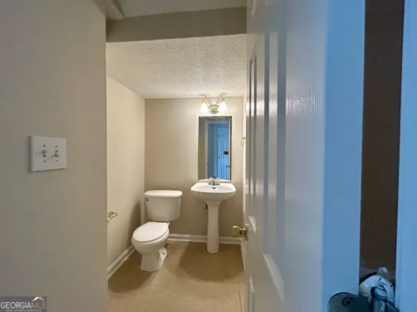 a white toilet sitting next to a bathroom sink