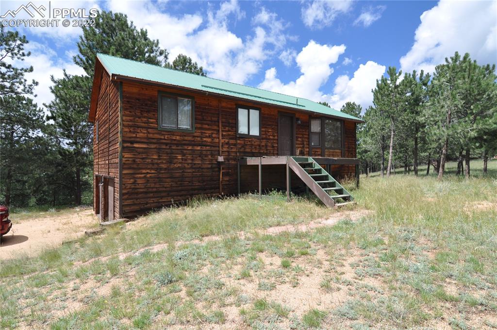 421 Maroon Lake Circle Divide, CO 80814 - Photo 1 of 19 a backyard of a house with a large tree