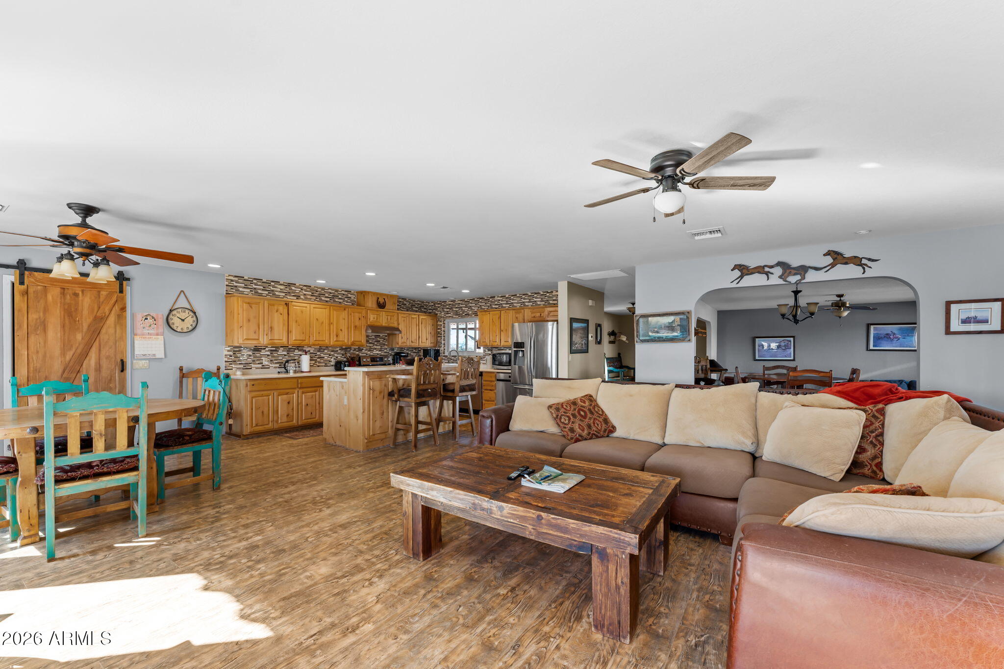 35085 South Turtle Creek Road Wickenburg, AZ 85390 - Photo 11 of 55 a living room with furniture kitchen view and a chandelier