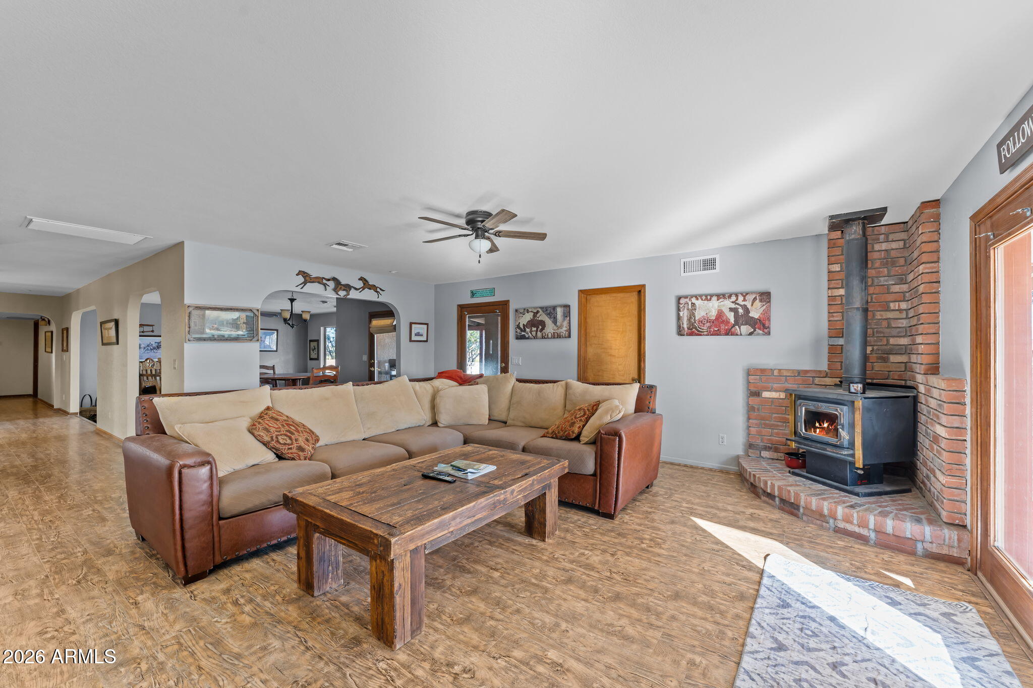 35085 South Turtle Creek Road Wickenburg, AZ 85390 - Photo 12 of 55 a living room with furniture a rug and a flat screen tv