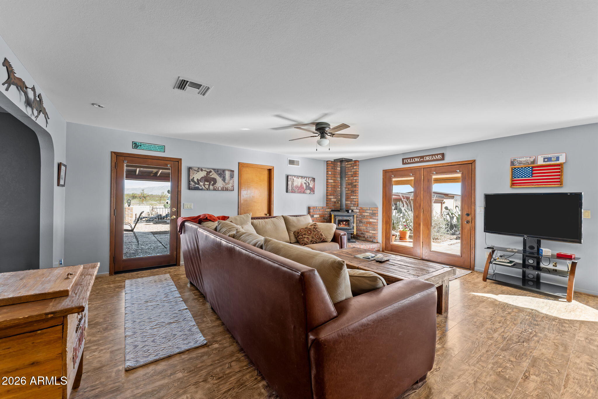 35085 South Turtle Creek Road Wickenburg, AZ 85390 - Photo 13 of 55 a living room with furniture and a flat screen tv