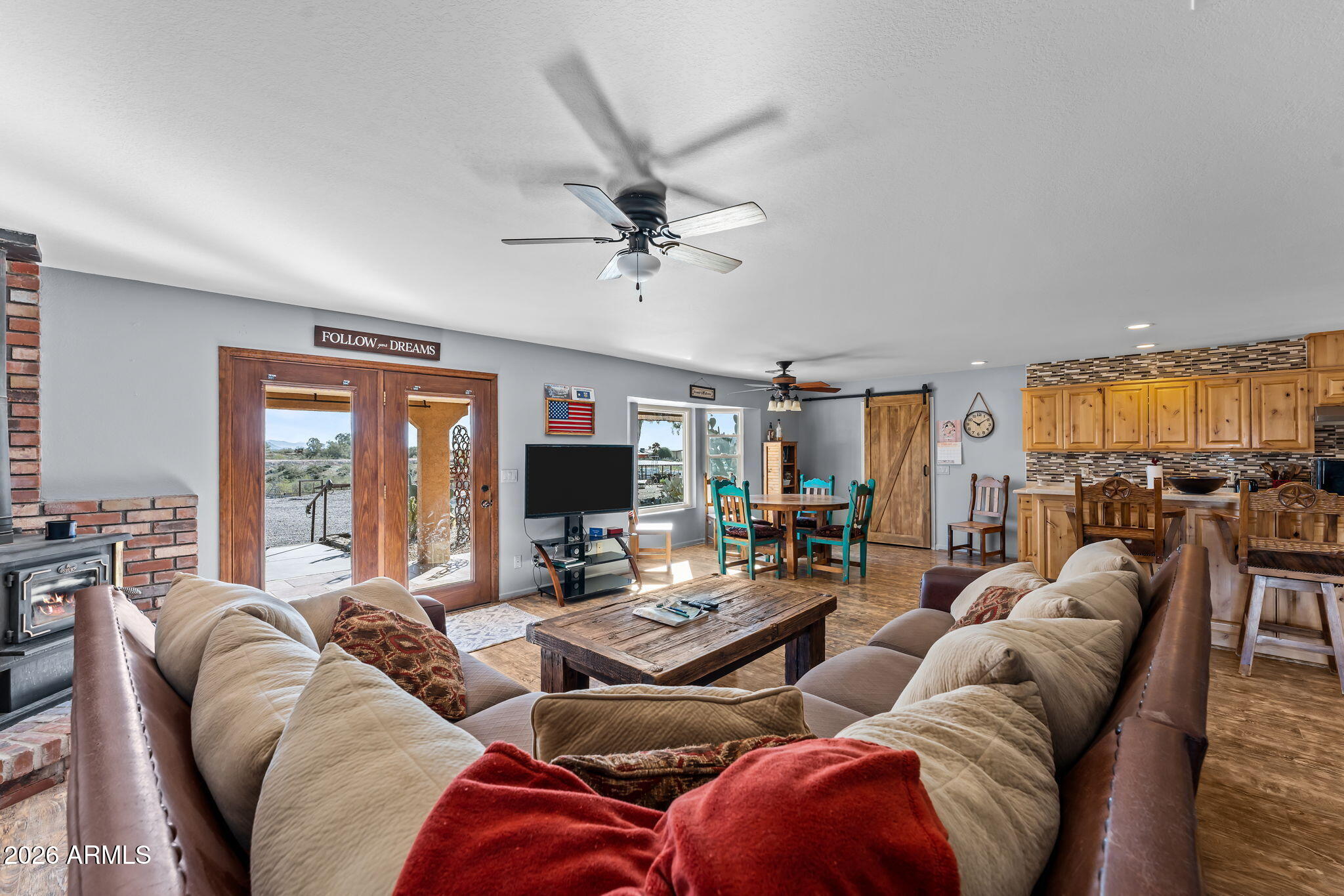 35085 South Turtle Creek Road Wickenburg, AZ 85390 - Photo 14 of 55 a living room with furniture ceiling fan and a large window