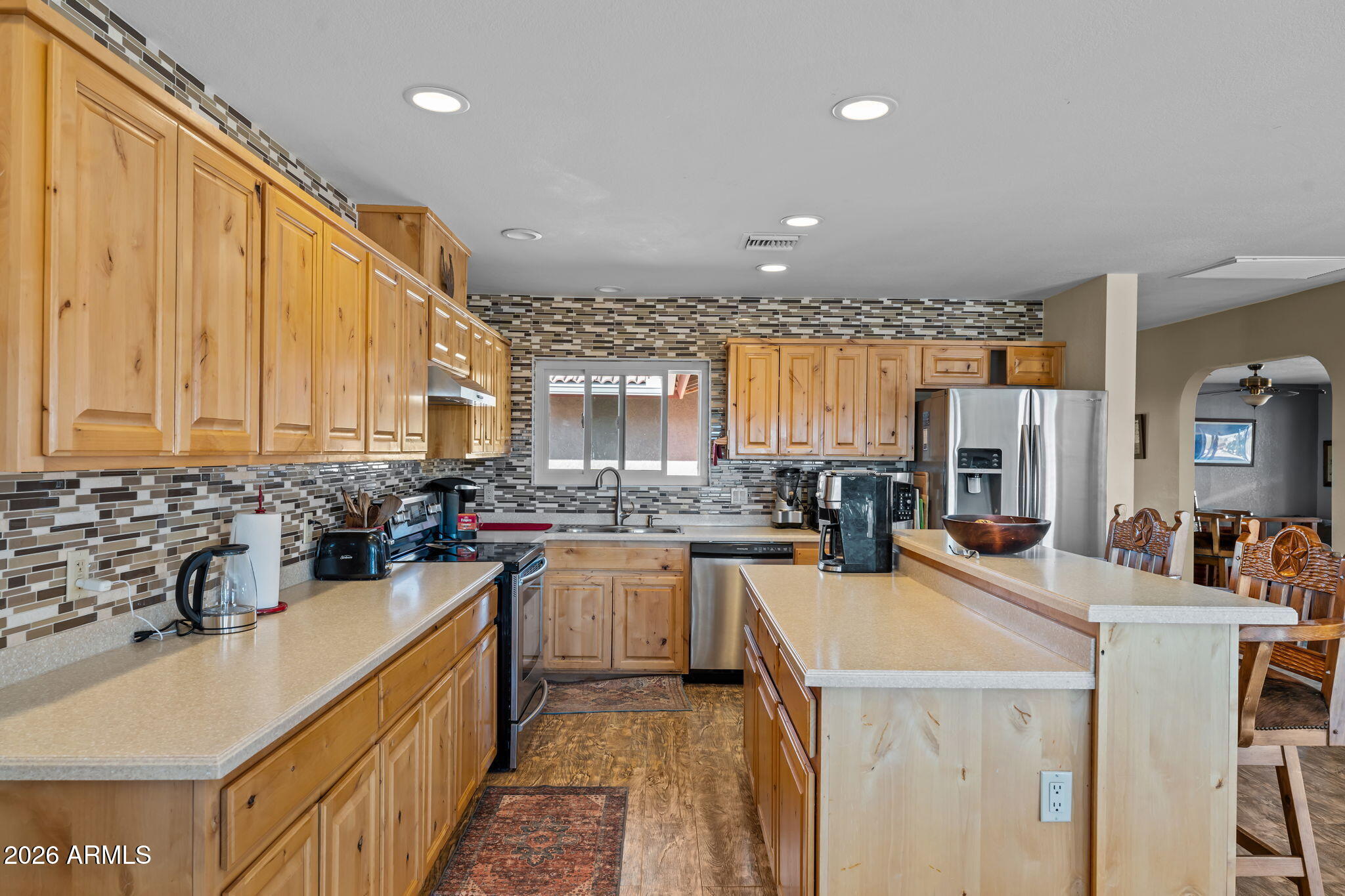 35085 South Turtle Creek Road Wickenburg, AZ 85390 - Photo 18 of 55 a kitchen with a sink a stove and cabinets