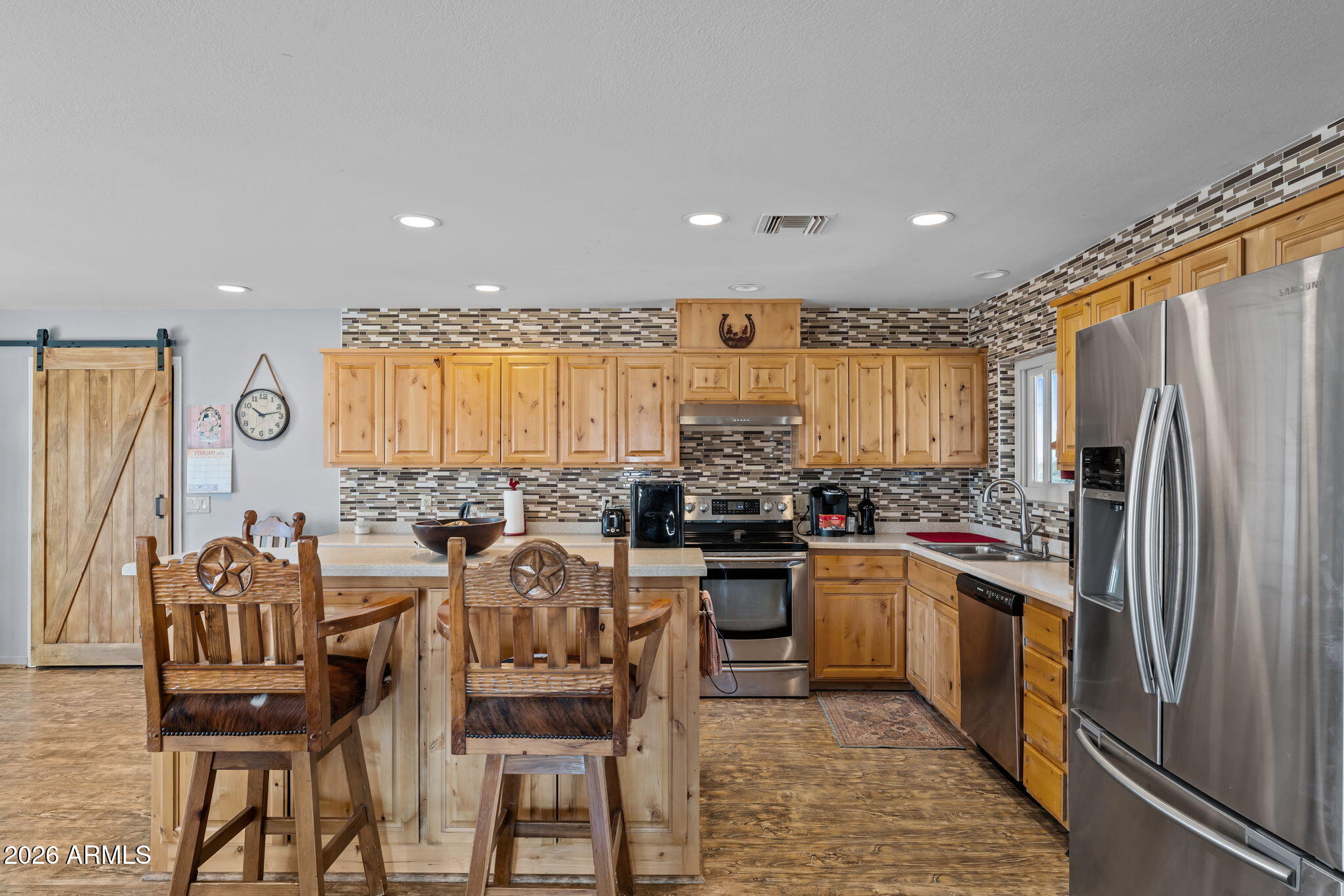 35085 South Turtle Creek Road Wickenburg, AZ 85390 - Photo 19 of 55 a kitchen with stainless steel appliances granite countertop a stove a refrigerator a kitchen island a stove and a refrigerator