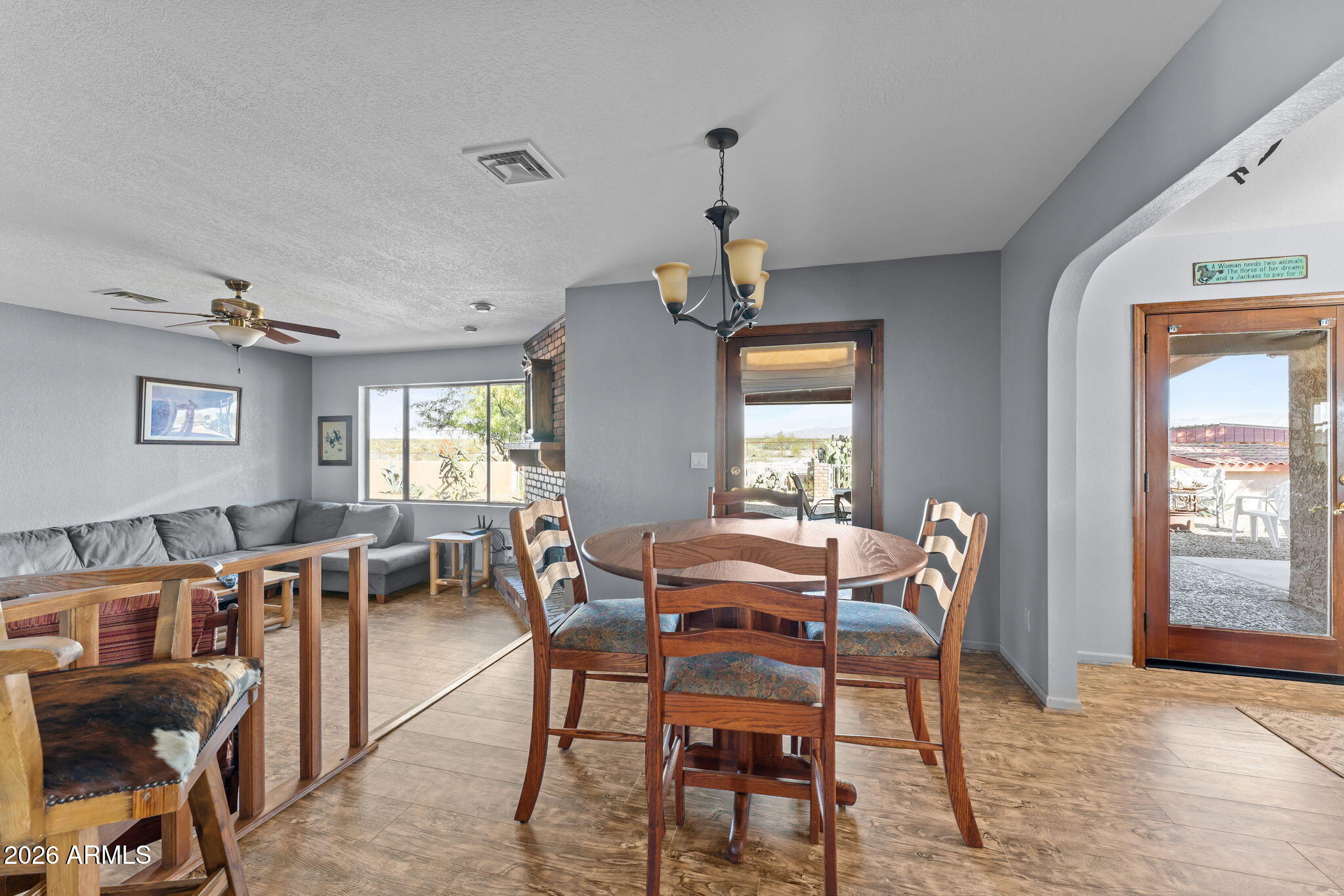 35085 South Turtle Creek Road Wickenburg, AZ 85390 - Photo 20 of 55 a view of a dining room with furniture window and wooden floor