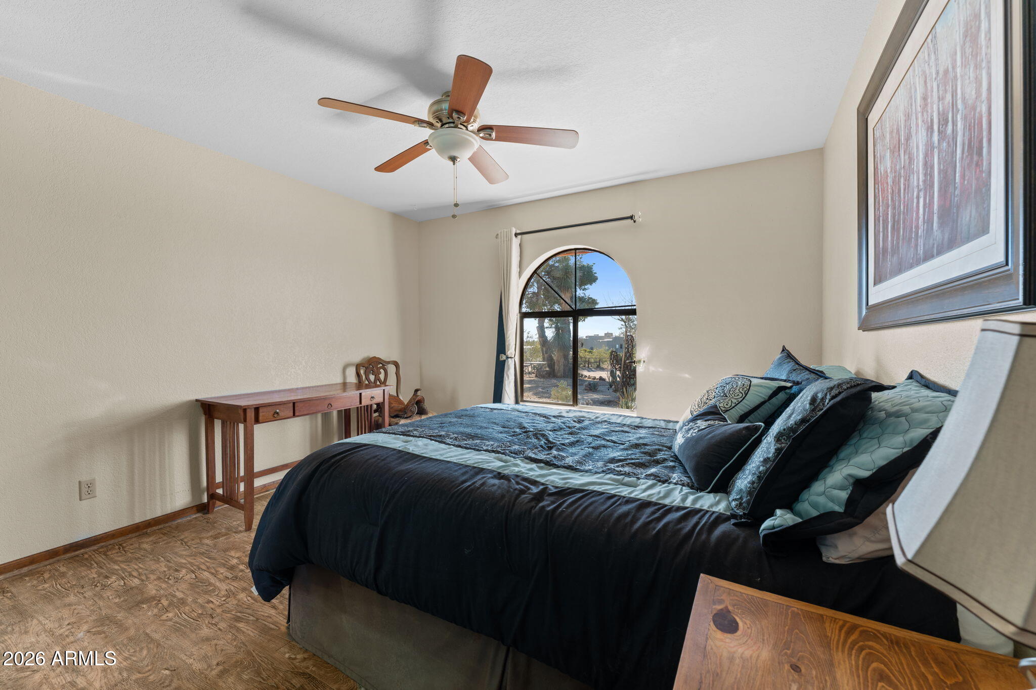 35085 South Turtle Creek Road Wickenburg, AZ 85390 - Photo 26 of 55 a bedroom with a bed and a chandelier