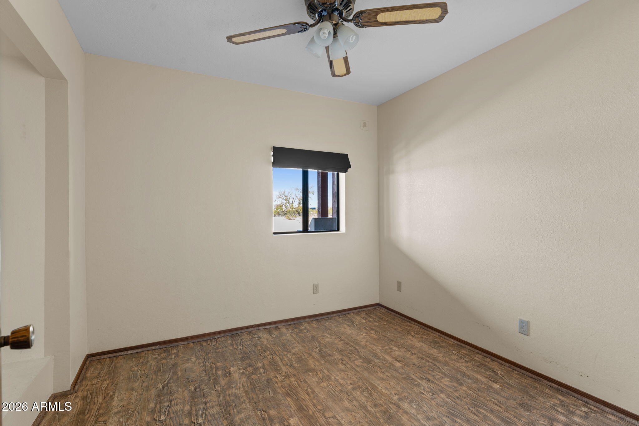 35085 South Turtle Creek Road Wickenburg, AZ 85390 - Photo 30 of 55 a view of a room with a hanging light and hardwood floor