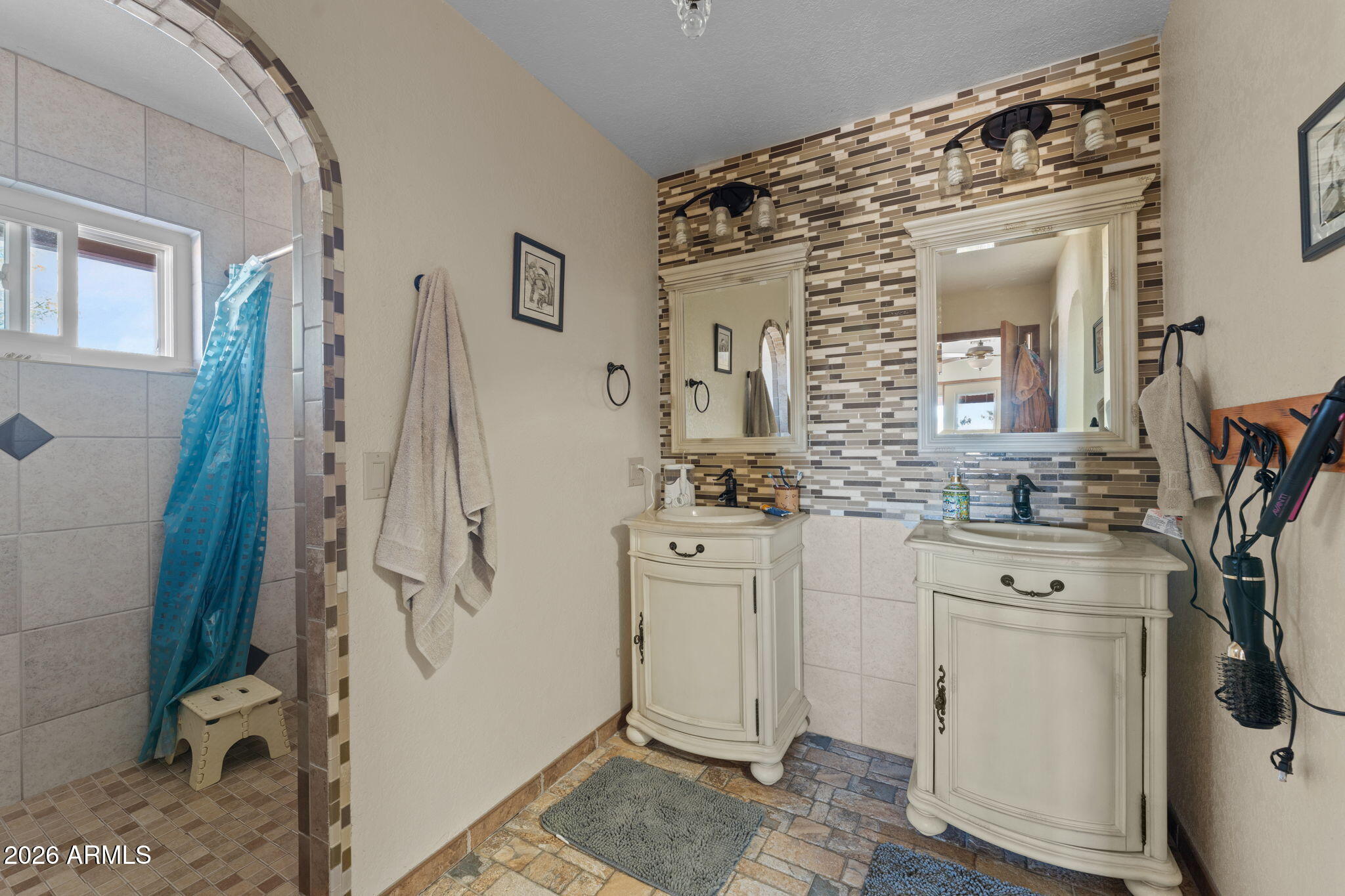 35085 South Turtle Creek Road Wickenburg, AZ 85390 - Photo 35 of 55 a bathroom with a sink a toilet and shower