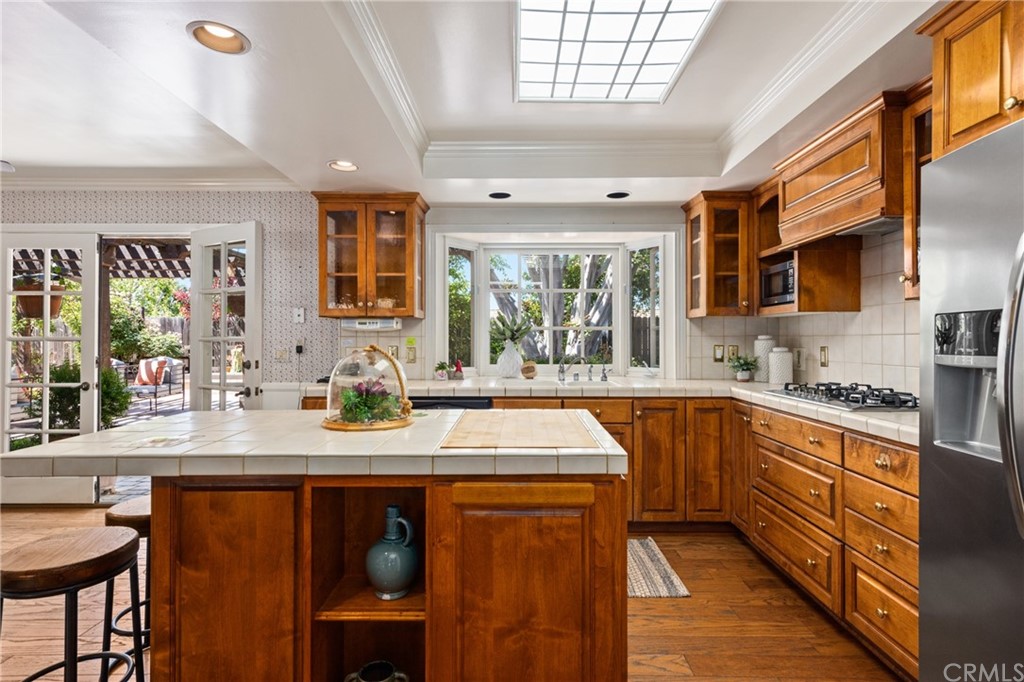 2012 Omega Drive North Tustin, CA 92705 - Photo 19 of 41 a kitchen with stainless steel appliances kitchen island granite countertop a sink and cabinets