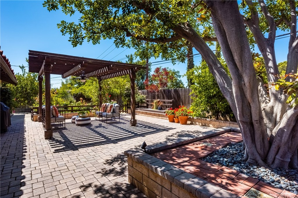 2012 Omega Drive North Tustin, CA 92705 - Photo 34 of 41 a view of a patio with table and chairs a fire pit and a large tree