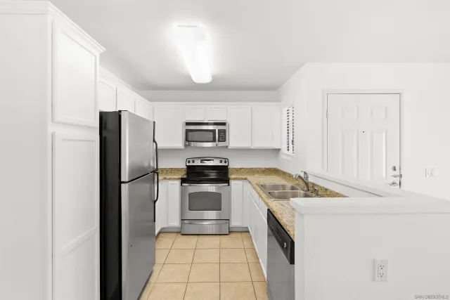 a kitchen with a refrigerator stove and sink