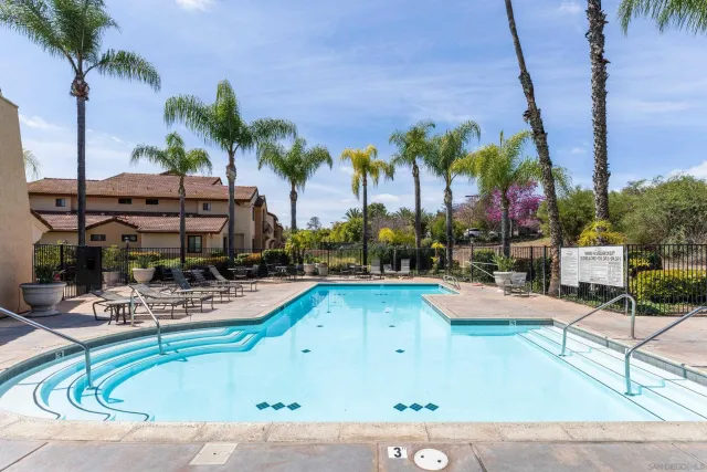 a view of a swimming pool with chairs