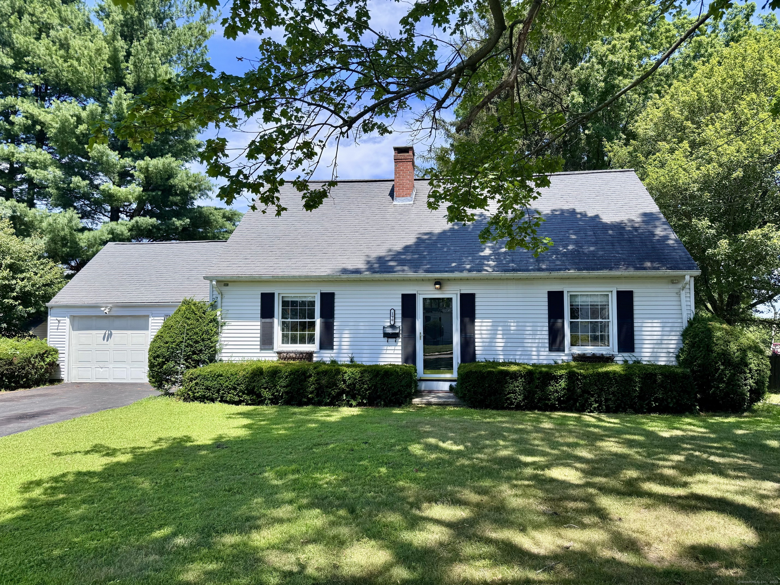 a front view of house with yard and green space