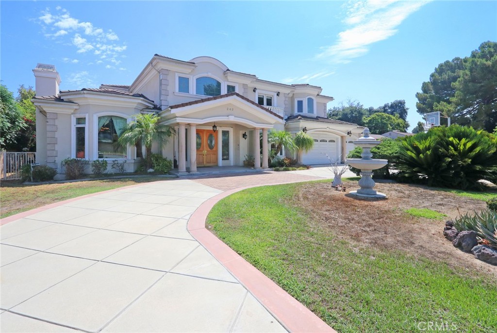 a front view of a house with a garden