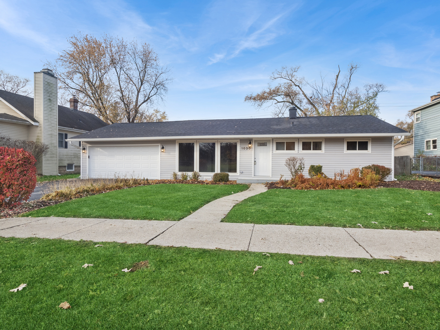 1030 Chestnut Street Deerfield, IL 60015 - Photo 7 of 11 a front view of a house with a garden and yard