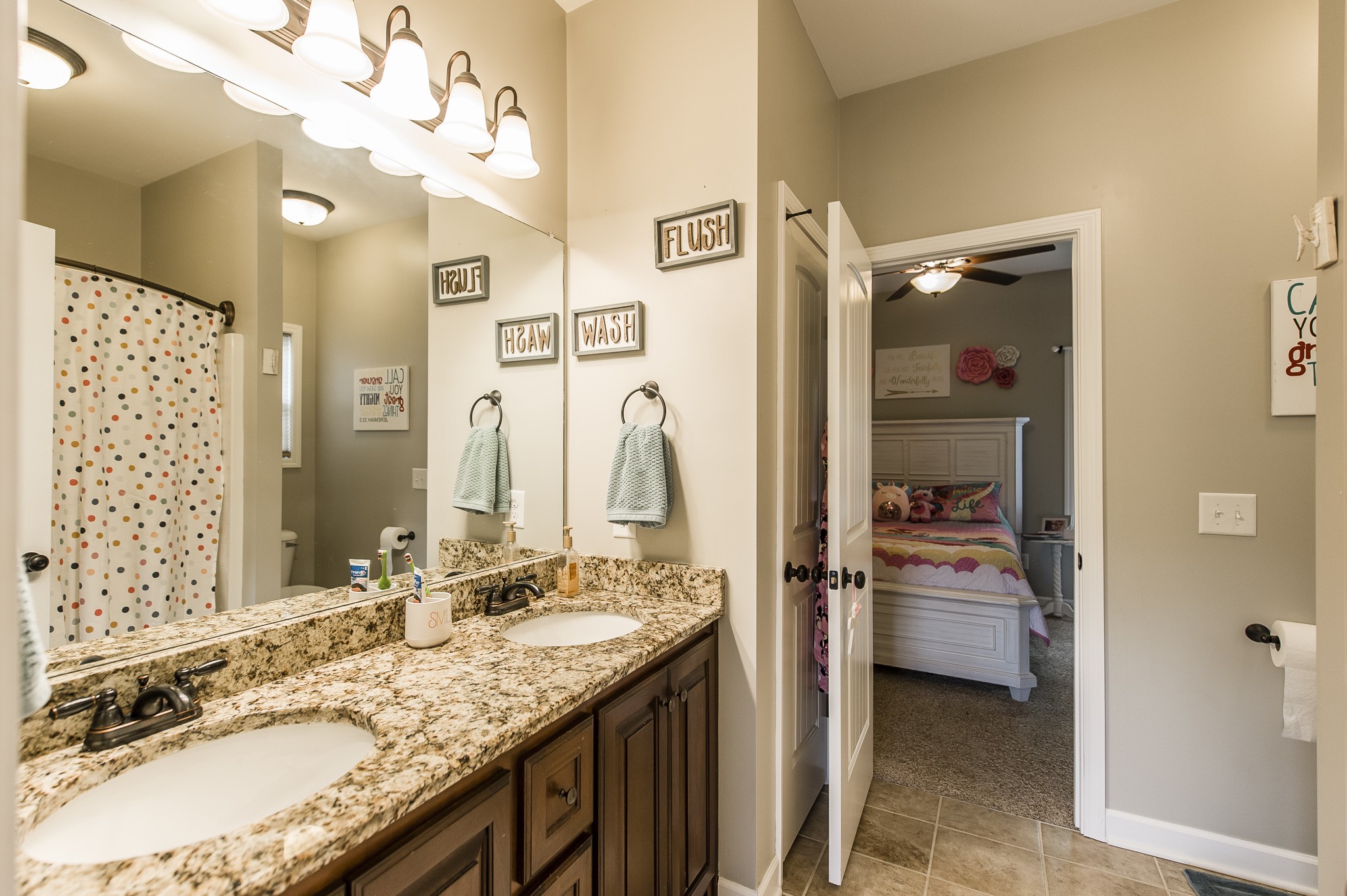 1145 Kimberly Drive Goodlettsville, TN 37072 - Photo 35 of 70 a bathroom with a granite countertop sink a mirror and shower