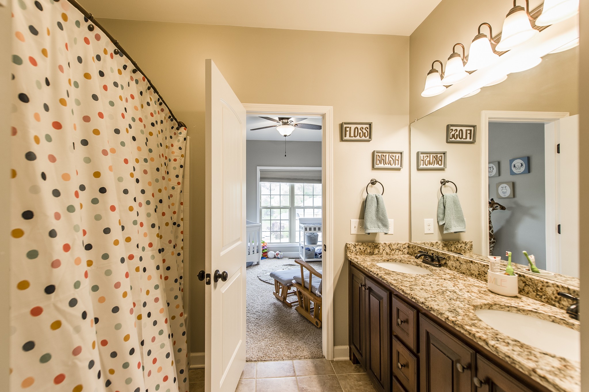 1145 Kimberly Drive Goodlettsville, TN 37072 - Photo 36 of 70 a bathroom with a granite countertop sink a large mirror and a shower