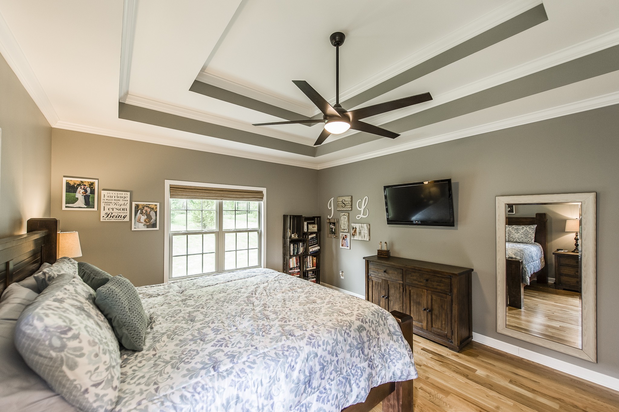 1145 Kimberly Drive Goodlettsville, TN 37072 - Photo 44 of 70 a bedroom with a large bed a flat tv screen and a fireplace