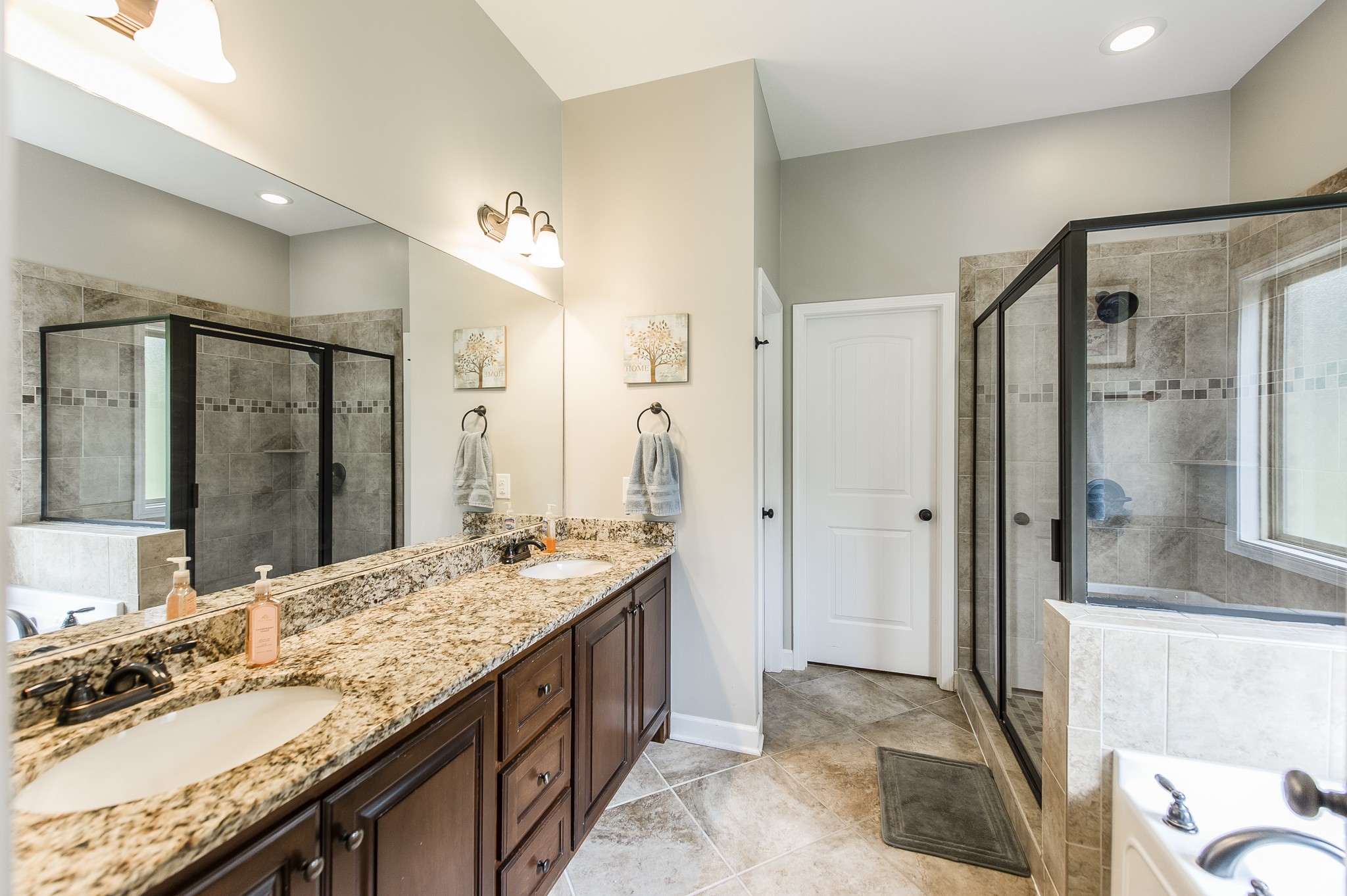1145 Kimberly Drive Goodlettsville, TN 37072 - Photo 45 of 70 a bathroom with a granite countertop sink mirror and shower